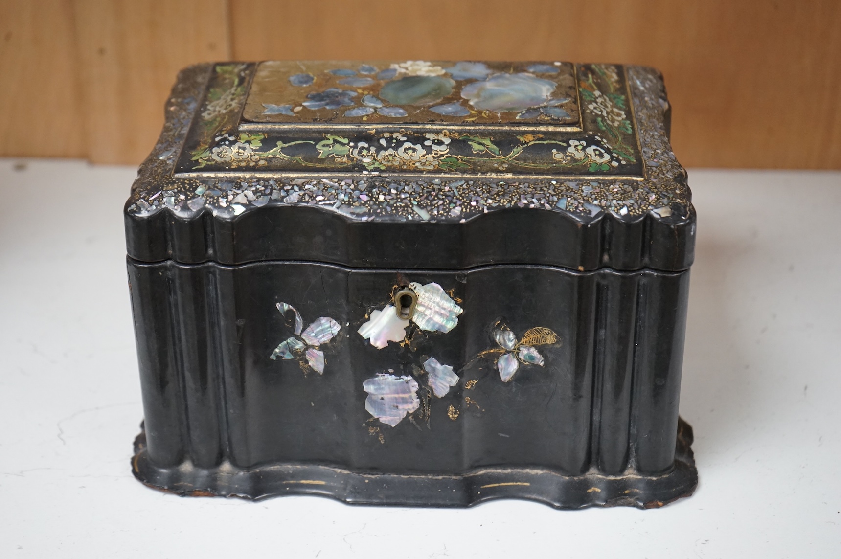 A Victorian Jennens & Bettridge papier mache tea caddy with abalone inlay, 21cm wide